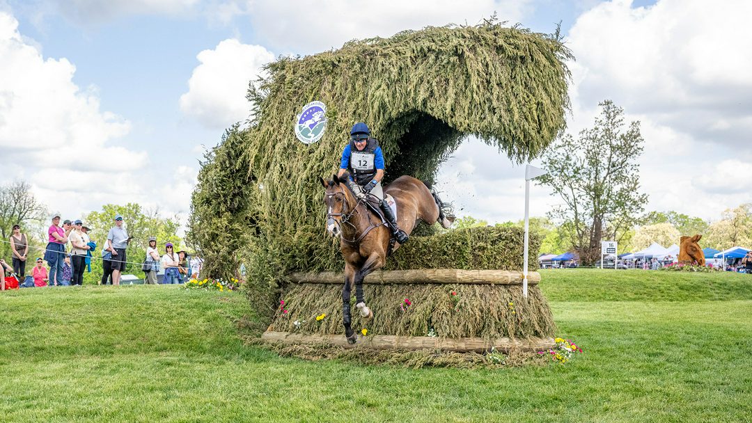 Phillip Dutton and Possante jump a brush fence with a curve of brush over the top of it at Kentucky Three-Day Event 2026