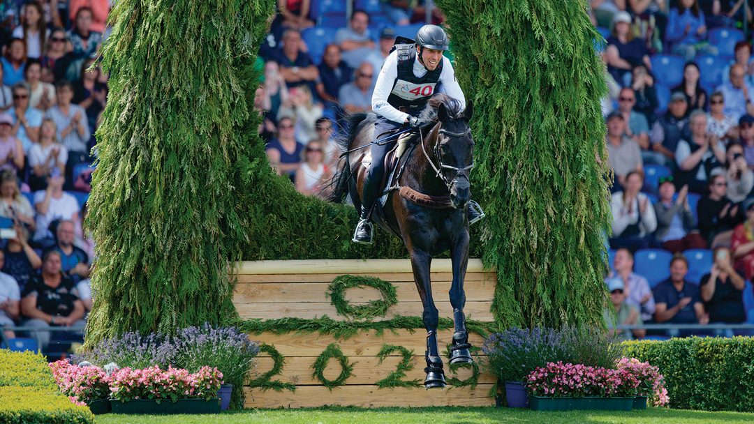 Jérôme Robiné and Black Ice jump a cross-country fence at Aachen 2025.