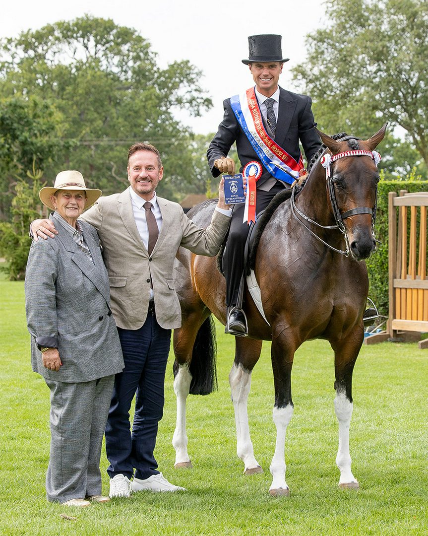 Harrison Taylor riding Lostock Up Till Dark at Royal International Horse Show is presented with award